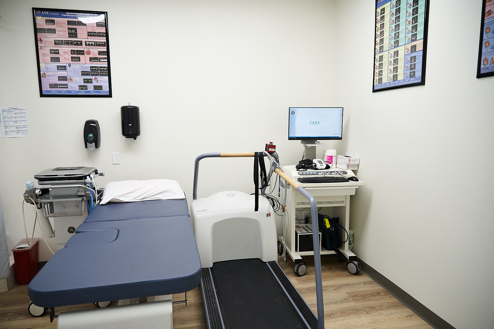 Cardiac testing room with treadmill stress test equipment, examination bed and ECG monitor