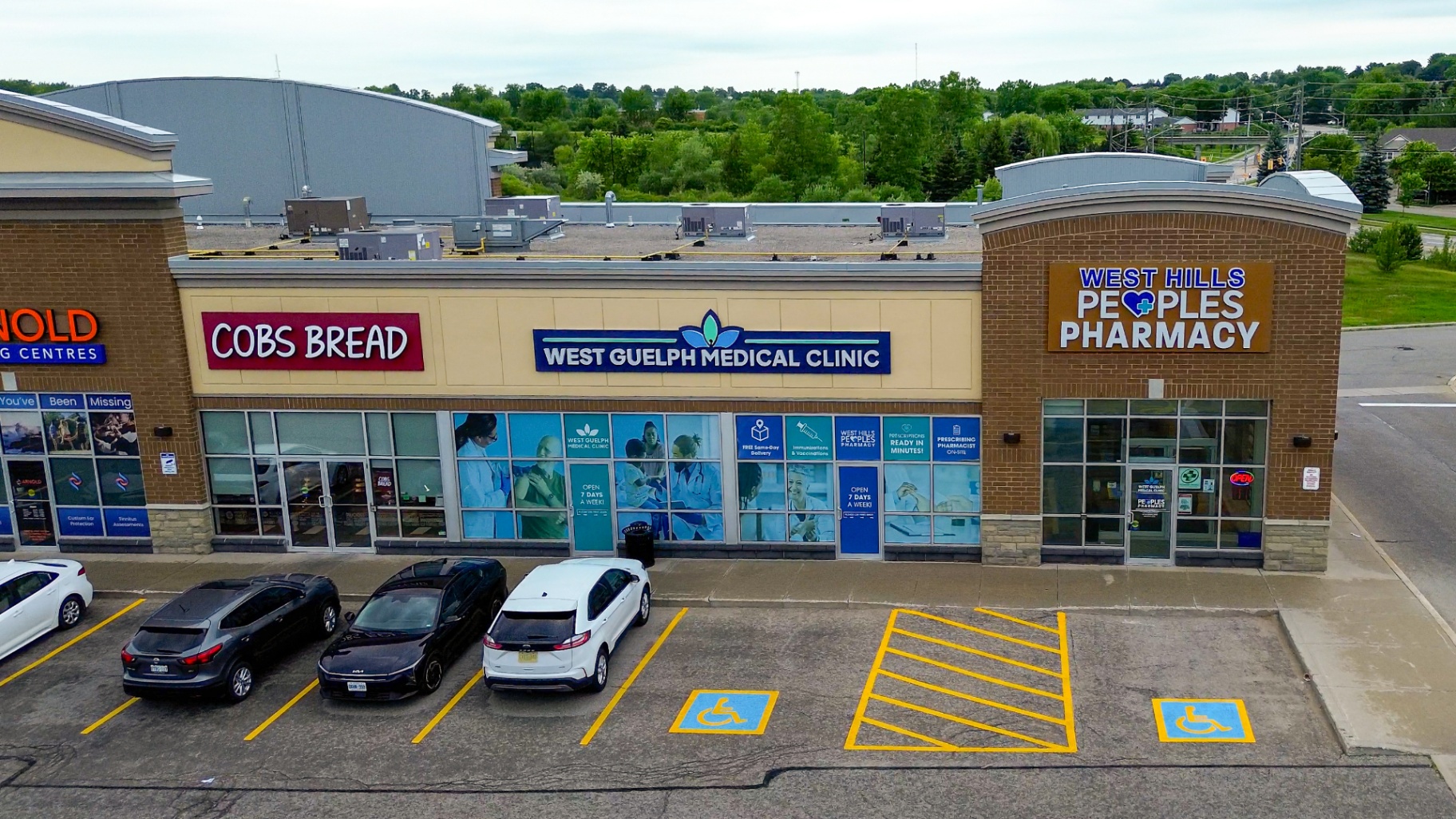 Exterior of West Guelph Medical Clinic at the plaza on Willow Road, with parking and accessible spaces in front